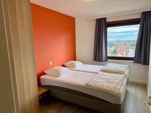 a small bedroom with two beds and a window at Apartment Bel-Air in Knokke-Heist