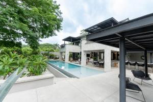 an exterior view of a house with a swimming pool at Villa De Vida Luxury Accomodations in Tangolunda