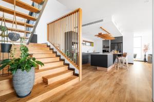 a staircase in a home with a kitchen and a living room at The Lookout, Albany Holiday House in Albany