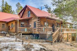 a log cabin with a red roof and a deck at BBQs, Hikes & Fireside Nights: Cabin in Black Hawk in Black Hawk