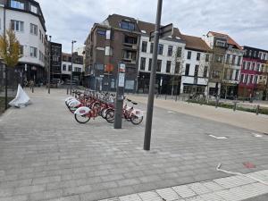 a row of bikes parked on a city street at Schijnpoort in Antwerp