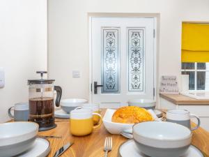 a wooden table with plates and bowls of food on it at Court Terrace in Ripon