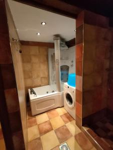 a small bathroom with a washing machine and a sink at Giusvalla Forest Villas & Retreat, Liguria in Dego +126 photos