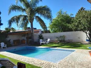 a swimming pool in the backyard of a house at Pura Brisa in Almafuerte