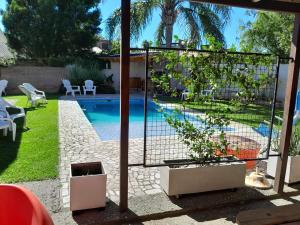 a swimming pool in a backyard with a fence around it at Pura Brisa in Almafuerte