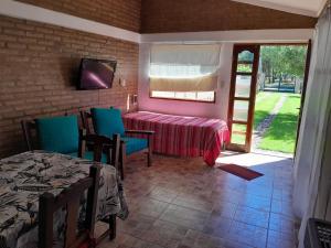 a room with a table and chairs and a window at Pura Brisa in Almafuerte