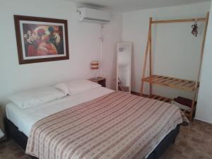 a bedroom with a bed and a painting on the wall at Pura Brisa in Almafuerte +12 photos