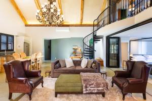 a living room with a couch and two chairs at Devon Castle Forest Lodge in Stellenbosch