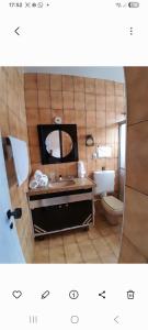 a bathroom with a sink and a mirror at Alto Astral in Fortaleza