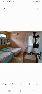 a bedroom with a bed and a desk in a room at Alto Astral in Fortaleza