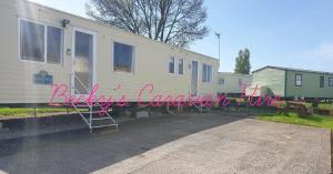 a house with a sign that reads backyard camper conversion at Becky's Caravan at Marton Mere in Blackpool