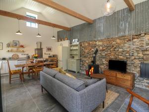 a living room with a couch and a stone fireplace at Bohan Bo in Kilmuckridge