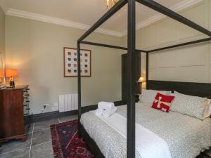 a bedroom with a black canopy bed in a room at Bohan Bo in Kilmuckridge