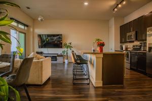 a kitchen and living room with a couch and a counter at Downtown views by the Lake in Austin