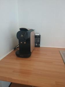a coffee maker sitting on top of a wooden table at Namur cozy apartment in Namur