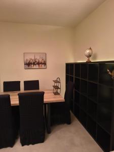 a dining room with a wooden table and chairs at Namur cozy apartment in Namur