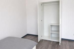 a bedroom with a bed and a mirror at Monteur- und Ferienunterkunft Waghäusel in Waghäusel
