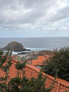 a view of the ocean from the roofs of a town at Casa da Torre in Porto Moniz +20 photos