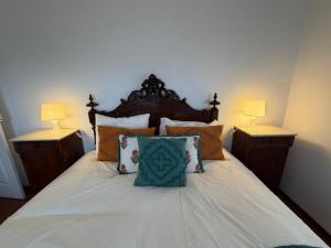 a bedroom with a bed with two lamps on it at Casa da Torre in Porto Moniz
