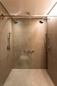 a shower with a glass door in a bathroom at Livramento Palace Hotel in Vitória da Conquista +27 photos