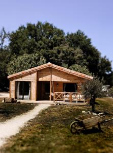 a log cabin with a bike in front of it at Chalet romantique - Jacuzzi privatif - King size in Montignac-Charente