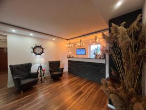 a living room with two chairs and a fireplace at MiraMar - Parking, wi-fi, Kuchnia ogólnodostępna in Krynica Morska +95 photos