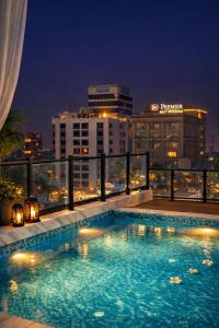 a swimming pool on top of a building at night at Daró - Self Check-in - 1 BR Apartment - Gulberg - MM Alam - Pool in Lahore