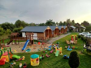 a group of houses with children playing in the yard at Ustecka Osada - Ustka in Ustka