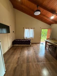 a living room with a bed and a table at Cabañas la flor in Puerto Piray