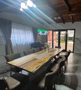 a conference room with a large wooden table and chairs at Vila Mery in Moisei
