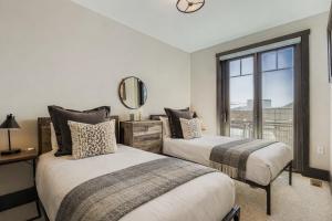 two beds in a room with a window at Tranquil Blackstone Getaway in Park City +69 photos