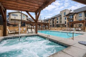 a swimming pool at a apartment complex with a building at Tranquil Blackstone Getaway in Park City