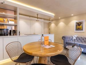 a kitchen and dining room with a wooden table and chairs at Palace by Wynwood House in Bogotá +12 photos