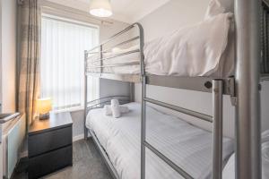 a bedroom with two bunk beds and a desk at 100 Waterside Park in Corton