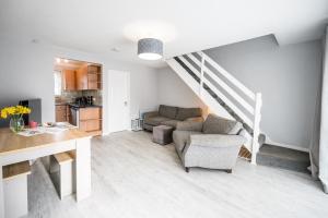 a living room with a couch and a staircase at 100 Waterside Park in Corton