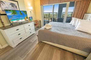 a bedroom with a bed with a television on a dresser at 2BR Pools, Direct Oceanfront Views, Handicap, Nice in Myrtle Beach