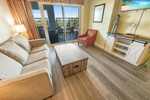 a living room with a couch and a table at 2BR Pools, Direct Oceanfront Views, Handicap, Nice in Myrtle Beach