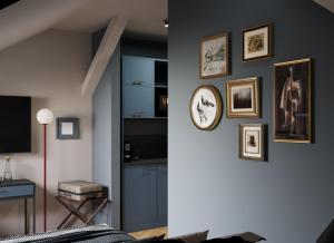 a living room with a clock on a wall at Maroon & Moss Residence in Budapest