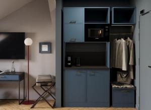 a room with a closet with a microwave and a desk at Maroon & Moss Residence in Budapest +102 photos
