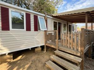 a mobile home with a porch and a deck at La Carabasse camping siblu in Vias