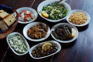 a table topped with bowls of different types of food at Agora Pansiyon in Kapıkırı