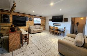 a living room with a couch and a dining room at CLR-Accommodation in George