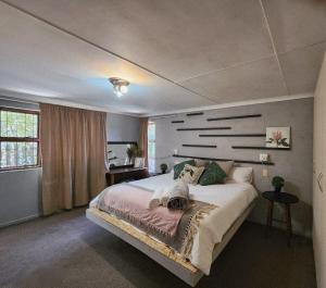 a bedroom with a large bed in a room at CLR-Accommodation in George +13 photos