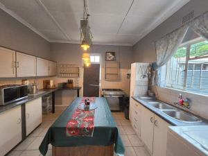 a kitchen with a table in the middle of it at CLR-Accommodation in George
