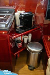 a kitchen with a counter with a toaster oven and a trash can at Barco no Coração da Cidade - Iate de 5 estrelas in Viana do Castelo +35 photos