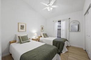 a bedroom with two beds and a ceiling fan at Cozy Coastal Cottage Minutes to Beach and Downtown in St. Augustine
