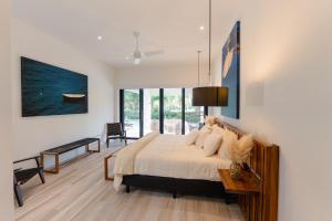 a bedroom with a large bed and a large window at Villa De Vida Luxury Accomodations in Tangolunda