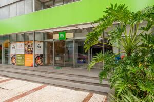 a store front of a building with a green facade at ibis Styles Belém do Pará in Belém