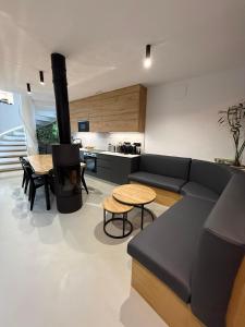 a living room with a couch and a table and a stove at Adiva A Zapataría in Puentedeume