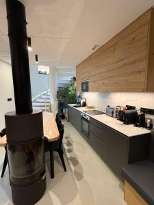 a large kitchen with a large stove in the middle at Adiva A Zapataría in Puentedeume